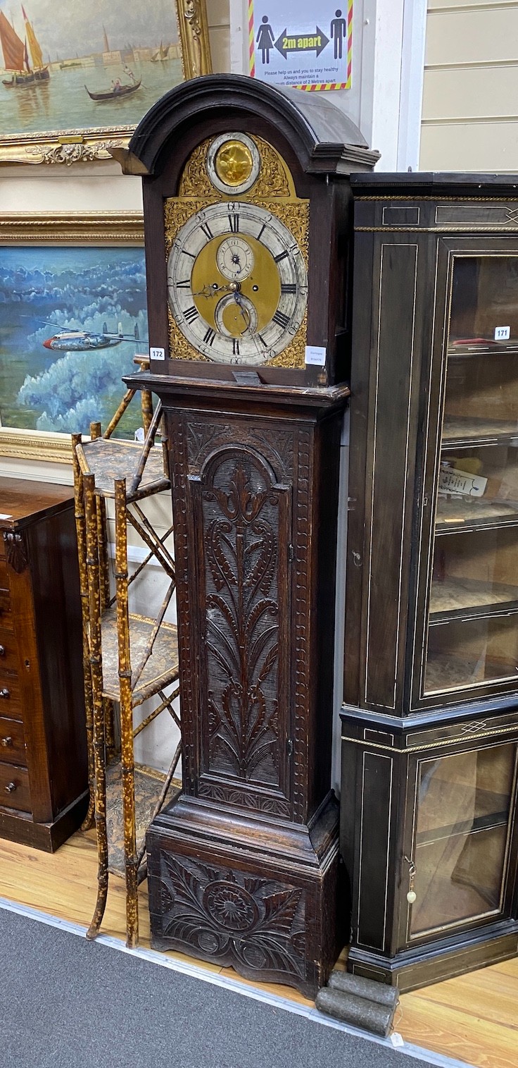 An 18th century oak 8 day longcase clock, with later carved decoration, the silvered chapter ring with Arabic and black Roman numerals with seconds dial and further subsidiary dial engraved Burroughs, Fordham, (requiring